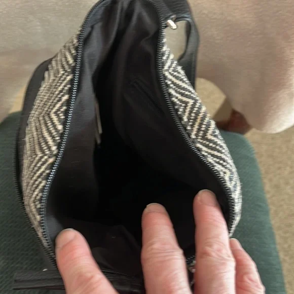 Black and white purse with two front zipper pockets. - Picture 3 of 3